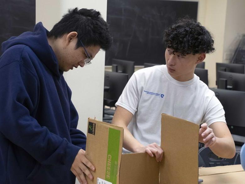 students working on cardboard boat